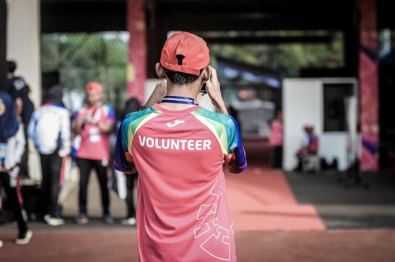 A volunteer in a bright event shirt at a community event